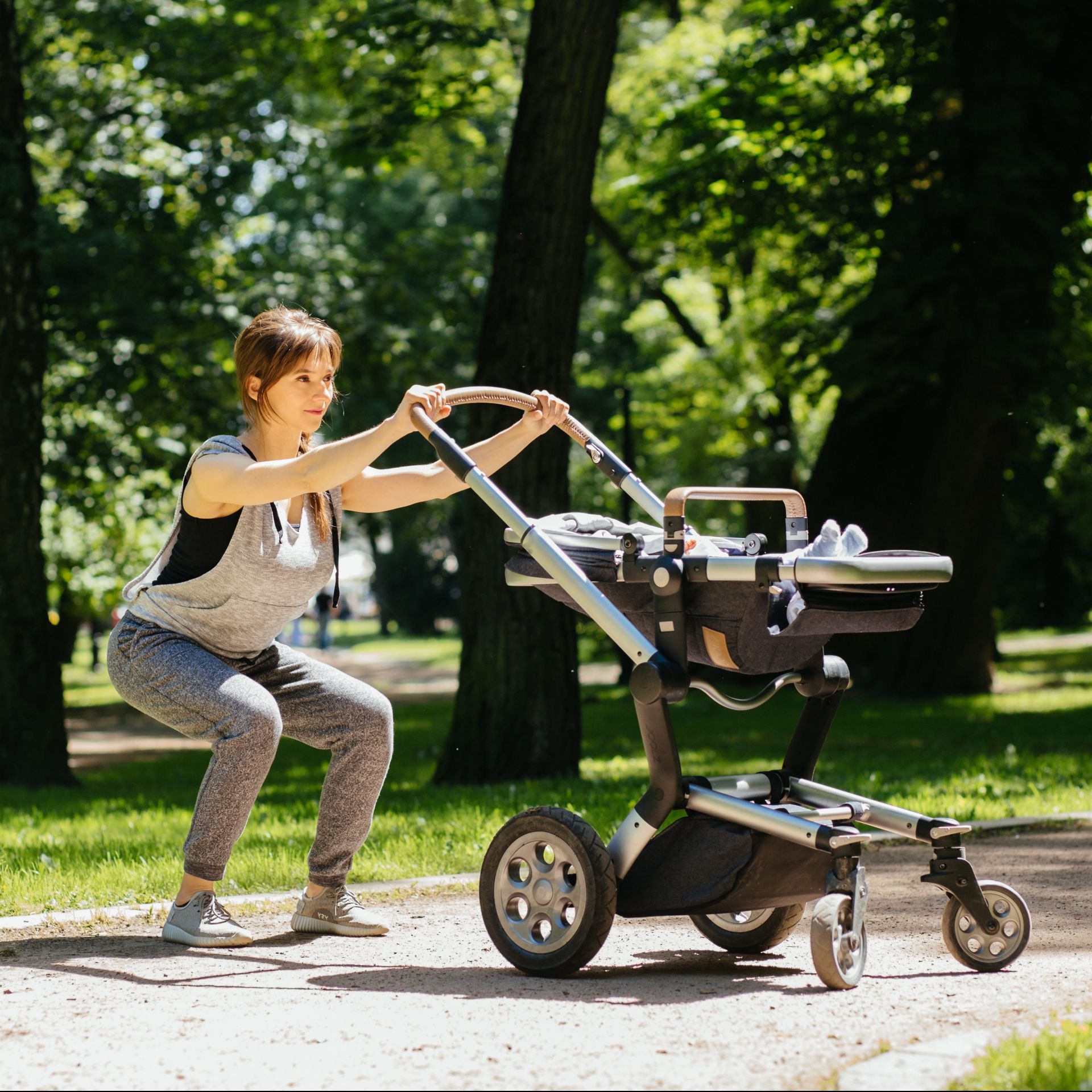 Series photo of happy sporty mother with baby pram workout and warming up bebore jogging in summer park.