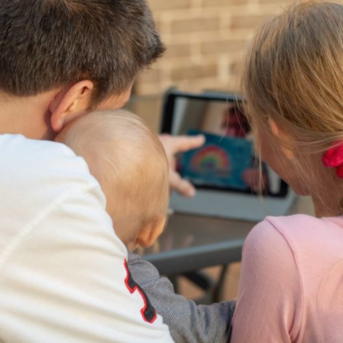 Family video chat - a man with two children using tablet for communication